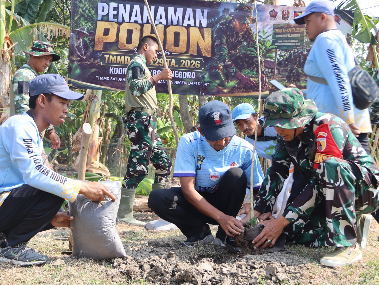 Satgas TMMD ke-129 Kodim 0813 Bojonegoro bersama Pemdes Kesongo, DLH, mahasiswa, dan masyarakat menanam bibit pohon dalam kegiatan penghijauan di Desa Kesongo, Kecamatan Kedungadem, Bojonegoro, Jumat (7/8/2026).